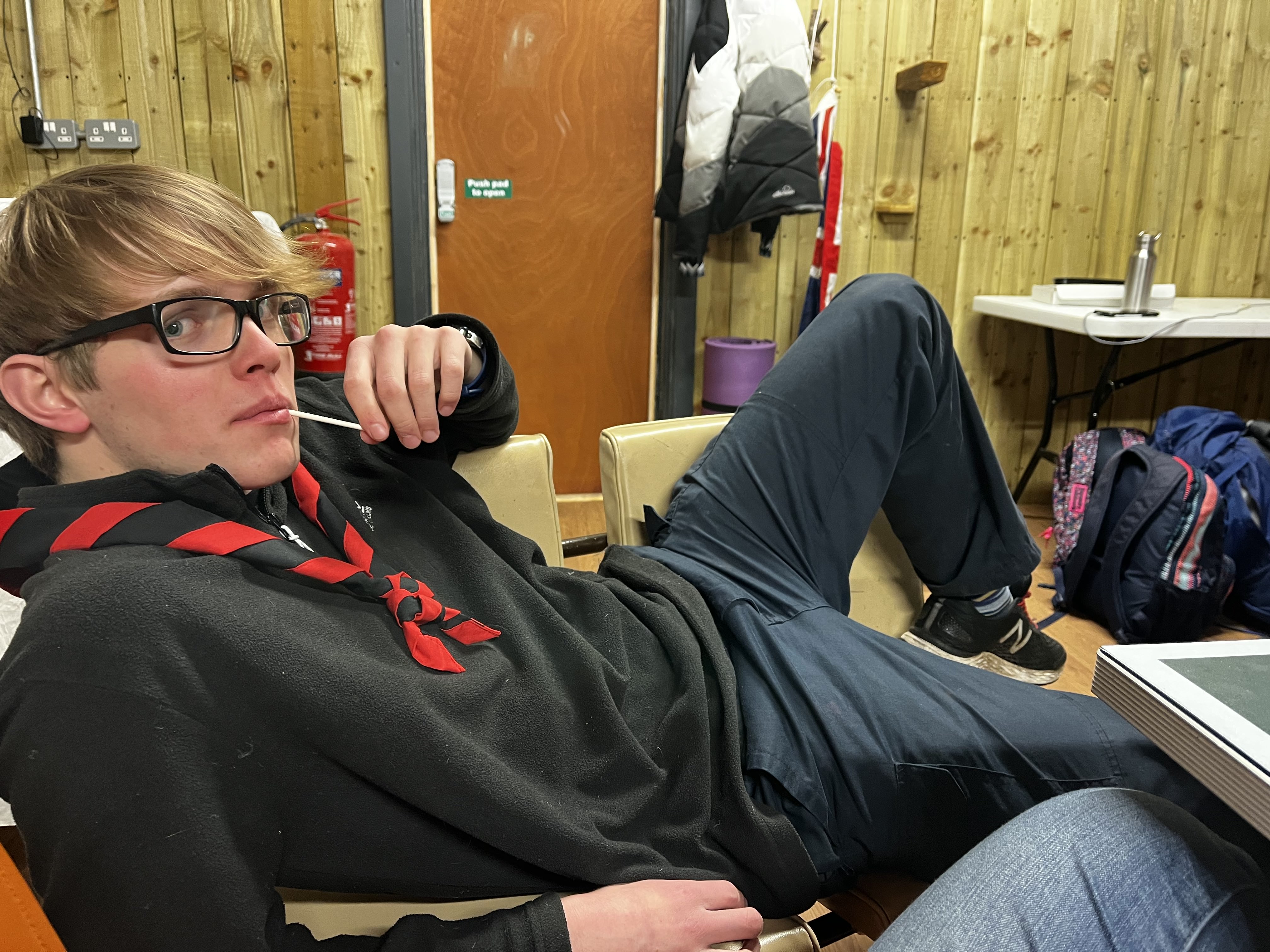 Me lying across 2 chairs with a lolly at Big BUSAG Breakfast 2023